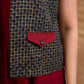 Sharp dark teal and maroon checkered sleeveless jacket with a distinctive notch collar and princess-cut tailoring, offering a structured silhouette ideal for elevated corporate styling.
