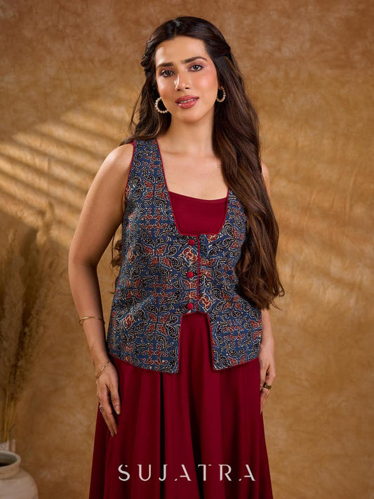 Handcrafted Ajrakh sleeveless jacket featuring front flaps, maroon detailing, breathable fabric, and a contemporary ethnic fusion appeal.