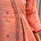 Peach dress featuring delicate Madhubani painting and graceful flared sleeves.