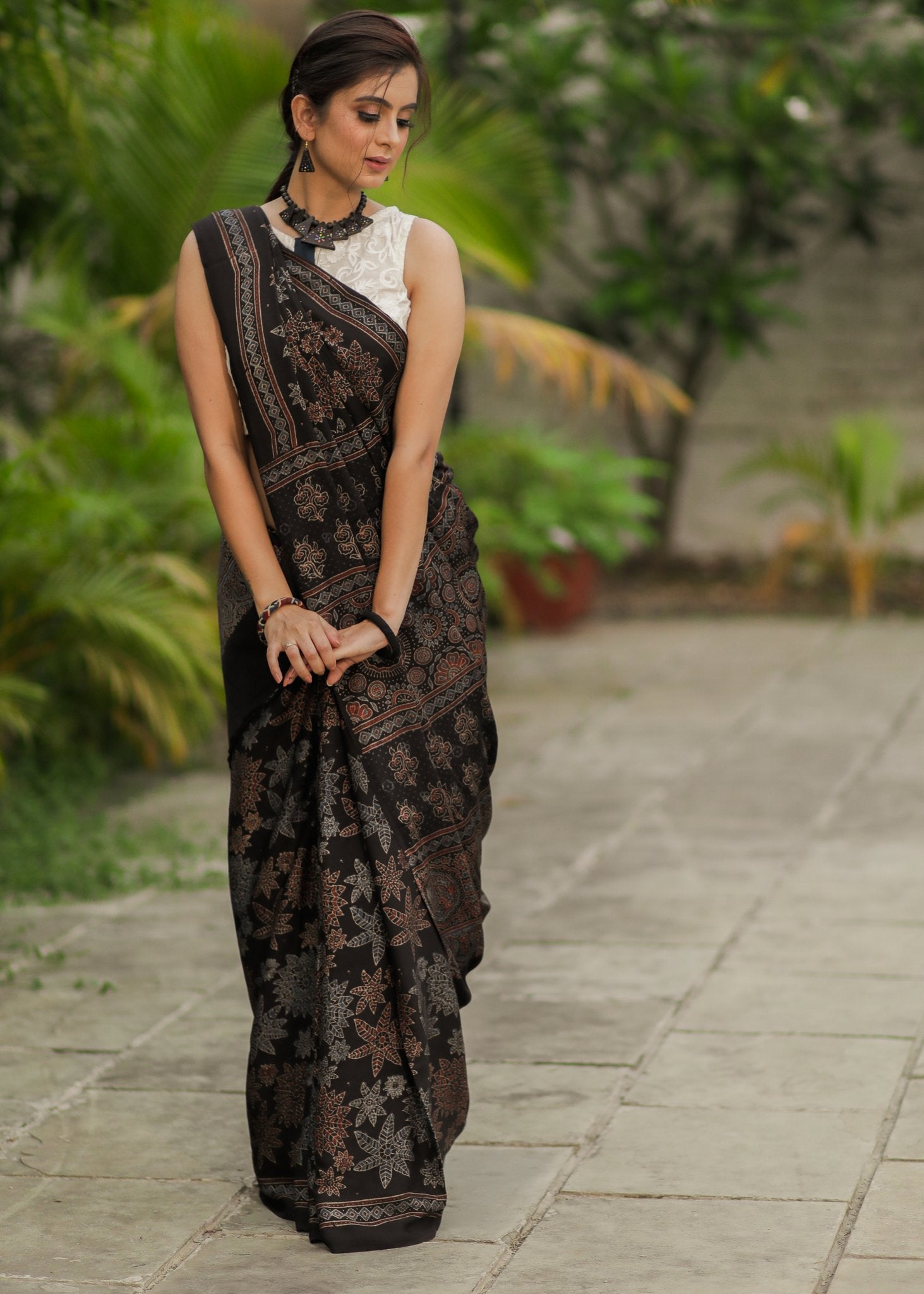 Pure modal silk ajrakh block printed black designer saree with floral motifs