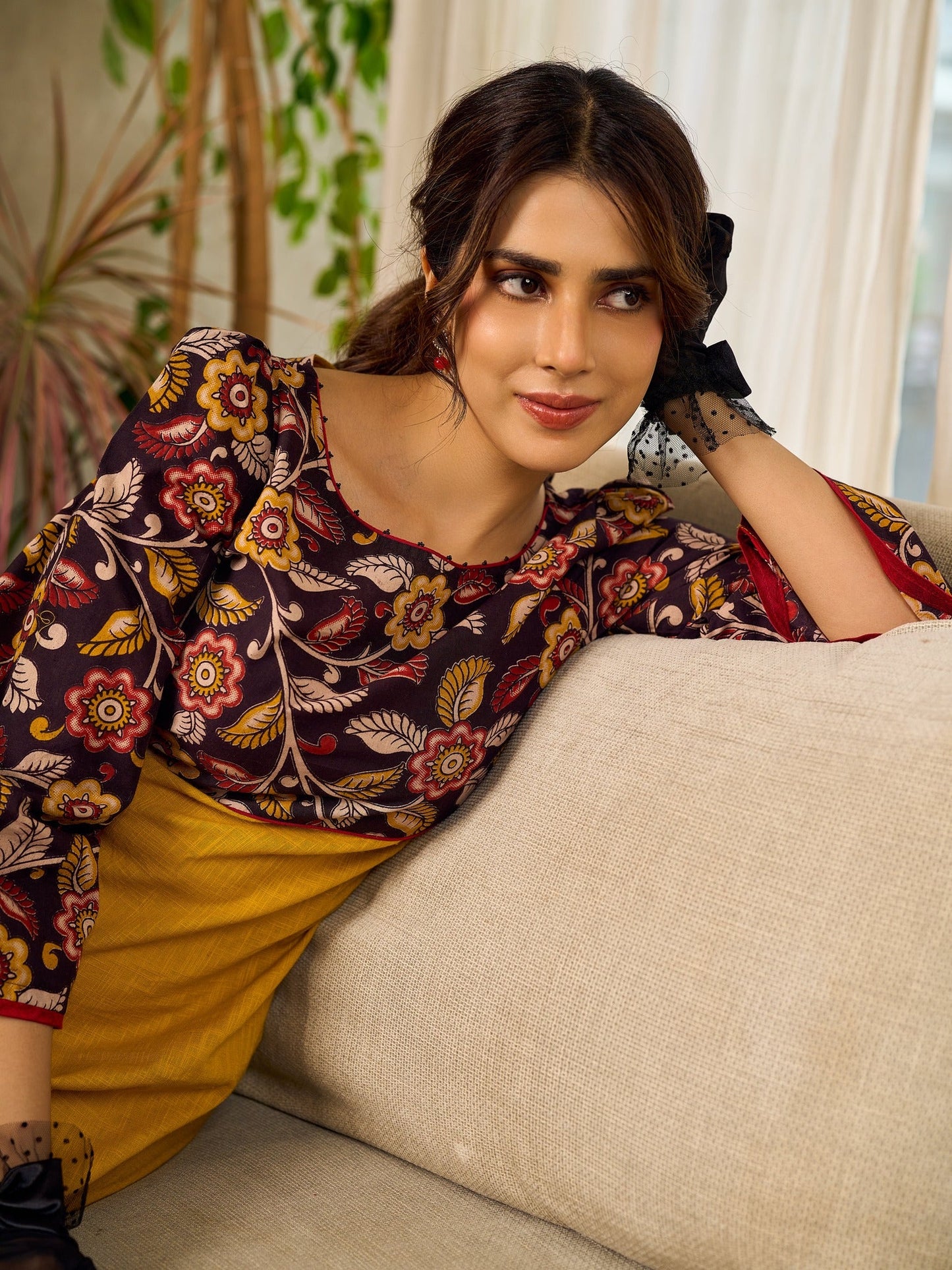 Mustard Kalamkari dress with an asymmetrical yoke and puffed sleeves.