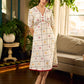 Soft off-white block printed rayon dress with intricate all-over hand block printed checks and florals, a gently gathered yoke, and rich red accents for a refined, elegant everyday look.