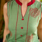 Pista sleeveless block printed dress with red abstract motif panels, a contrasting red collar, and accents for a fresh, artisanal, contemporary look.