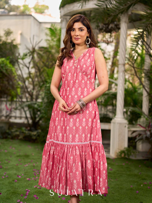 Graceful pink Ikat long dress accented in white, designed with gathered detailing at the fall and a clean sleeveless finish