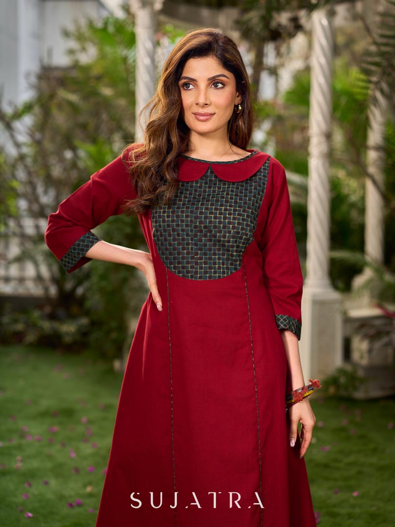Chic maroon dress featuring a contrasting teal neck patch with charming Peter Pan collar details