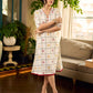 Soft off-white block printed rayon dress with intricate all-over hand block printed checks and florals, a gently gathered yoke, and rich red accents for a refined, elegant everyday look.