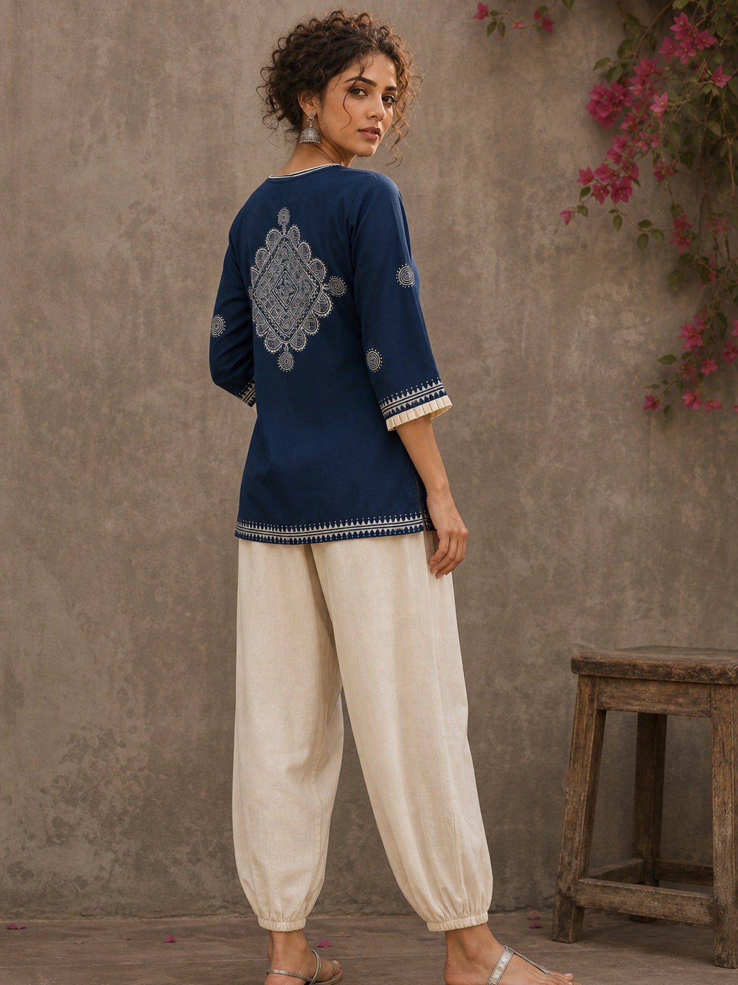 Captivating navy top adorned with a bold, rhythmic block print design, pleated sleeve detailing, and a versatile cut.