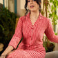 Peach and red block print stripe-floral shirt dress with fusion hand block printed stripes and jaal, a notch collar, and coordinated red accents for a vibrant, contemporary look.