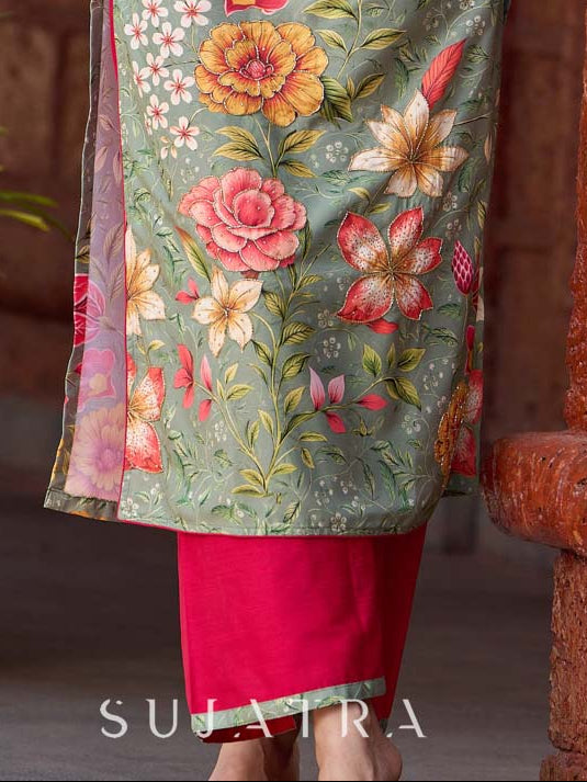 Soft green printed kurta with vibrant floral motifs, highlighted with hand embroidery and bright magenta accents.