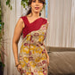 Elegant cream and maroon Madhubani dress featuring sophisticated wavy pintuck flap detailing.