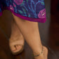 Enchanting purple panel dress featuring vibrant magenta floral prints, a sleeveless silhouette, and a graceful fit-and-flare design for timeless elegance.