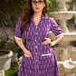 Purple Ikat dress with a notch collar, softly gathered sleeves, crisp white accents, a gently gathered upper waist, and functional slip-in pockets.