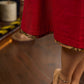 Elegant maroon dress featuring an attached artisan Kalamkari shoulder cape.