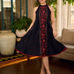 Black bias-cut block print halter dress with a red jaal hand block printed front panel, golden print detailing, and red accents for a striking, elegant statement look.