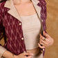 Smart maroon Ikat jacket featuring gathered sleeves, a cream notch collar, and subtle accents, creating a defined, structured silhouette suited for polished corporate wear.