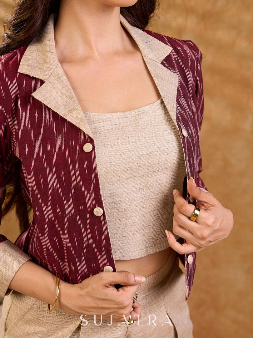 Smart maroon Ikat jacket featuring gathered sleeves, a cream notch collar, and subtle accents, creating a defined, structured silhouette suited for polished corporate wear.