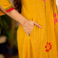 Mustard block printed pintuck dress with hand block red and pink vine floral motifs, accented with red and olive details for a rich, elegant look.