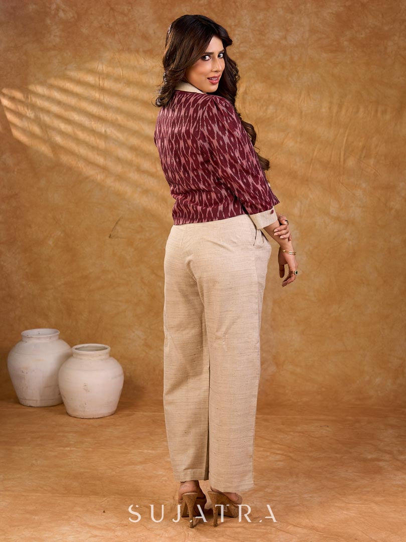 Smart maroon Ikat jacket featuring gathered sleeves, a cream notch collar, and subtle accents, creating a defined, structured silhouette suited for polished corporate wear.
