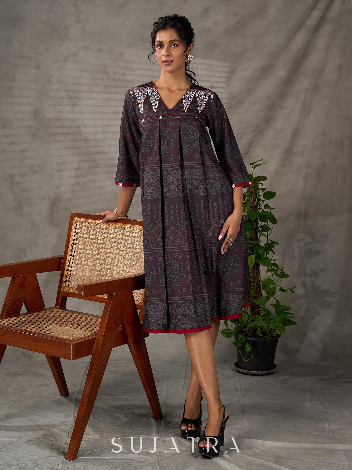 Black Ajrakh printed dress with pleats, maroon accents, and silver embellishments.