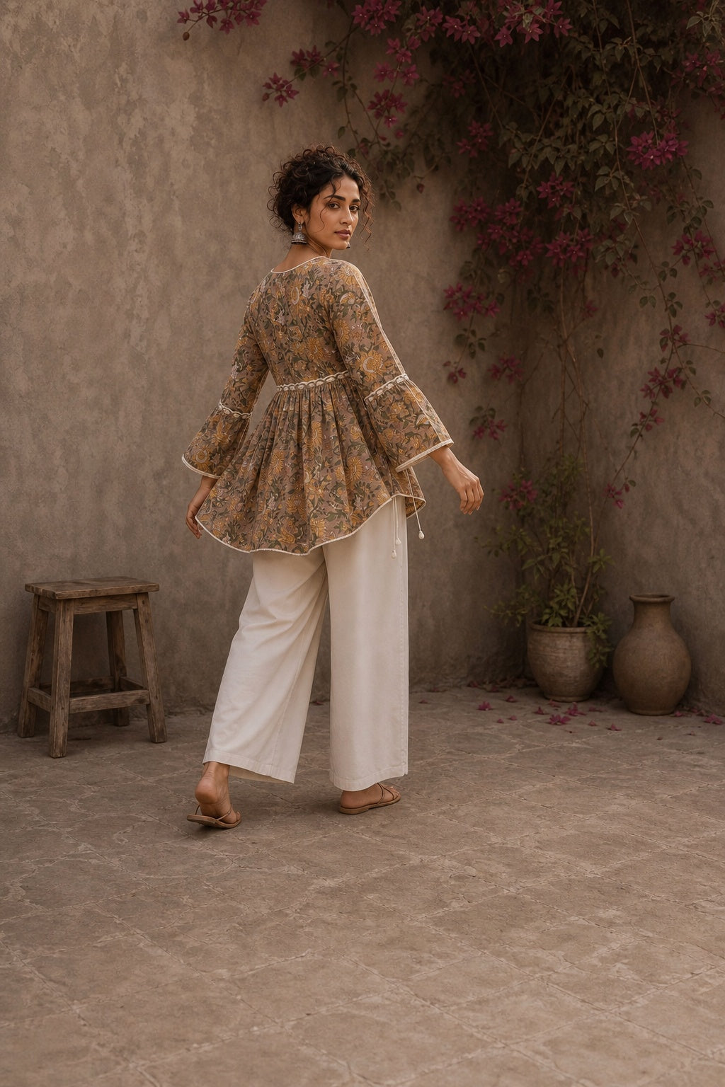 Romantic peach Jaipur floral top adorned with scalloped lace, gathered sleeve hems, and playful tie-knot accents.
