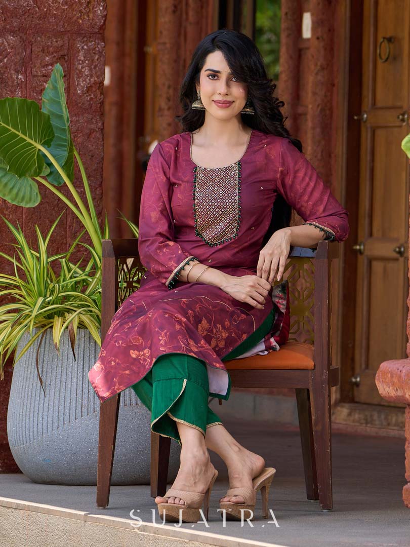 Exquisite deep burgundy printed kurta with intricate neck panel embroidery, delicate green beads, and refined green highlights.