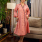 Peach dress featuring delicate Madhubani painting and graceful flared sleeves.