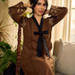 Brown block print dress with floral block printed flared sleeves, black tie-up neckline, and contrast black accents for an effortless, elegant everyday look.
