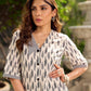 Modern white and grey Ikat shirt dress elevated with an asymmetrical checkered Ikat collar and contrast black accents.