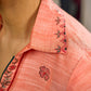 Peach dress featuring delicate Madhubani painting and graceful flared sleeves.