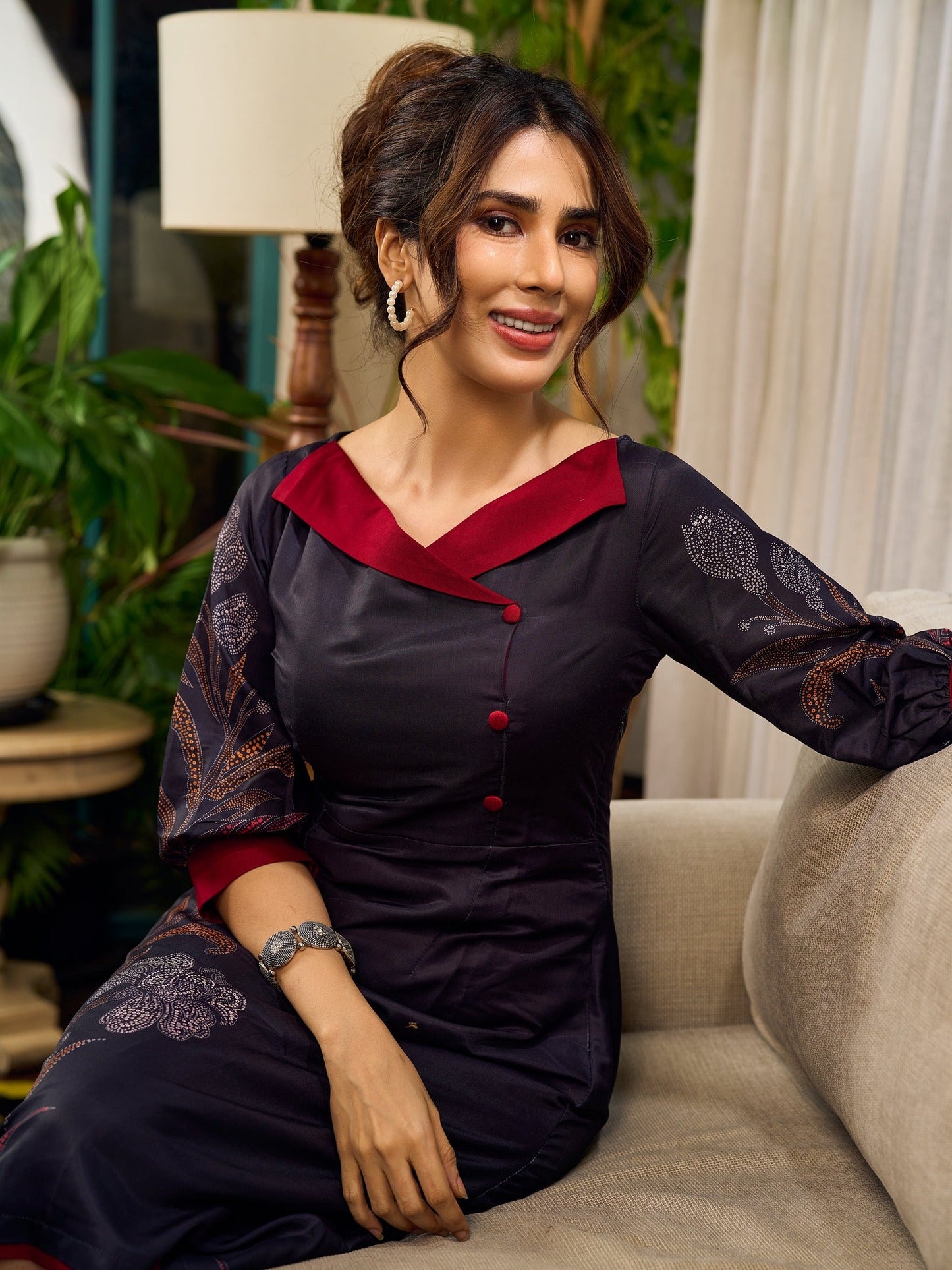 Elegant black Kalamkari-inspired dress with deep maroon accents and graceful floral motifs.