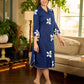Navy blue apple-cut shirt dress with white floral hand block motifs, conceptually placed and finished with clean white edging and red accents for a refined, contemporary look.