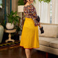 Mustard Kalamkari dress with an asymmetrical yoke and puffed sleeves.