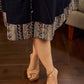 Modern black bias-cut dress showcasing unique artisan-inspired Kalamkari neck trim.
