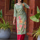 Soft green printed kurta with vibrant floral motifs, highlighted with hand embroidery and bright magenta accents.