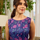 Enchanting purple panel dress featuring vibrant magenta floral prints, a sleeveless silhouette, and a graceful fit-and-flare design for timeless elegance.