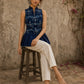 Contemporary indigo top with delicate dragonfly motifs, high folded collar, and graceful pleated hemline.