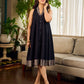 Modern black bias-cut dress showcasing unique artisan-inspired Kalamkari neck trim.
