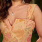 Effortless sunshine yellow floral dress designed with a delicate neckline, gathered straps, and a breezy, flowy form.