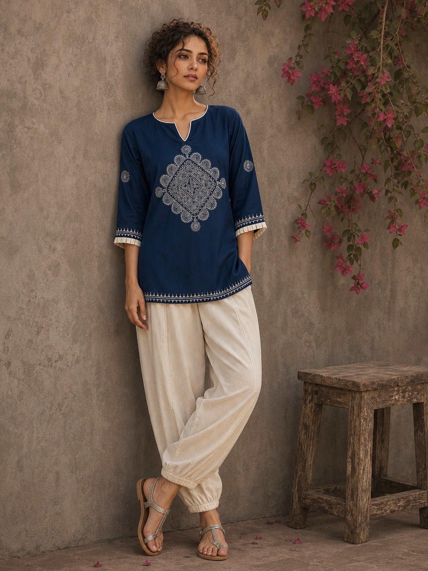Captivating navy top adorned with a bold, rhythmic block print design, pleated sleeve detailing, and a versatile cut.