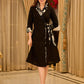 Chic black overlapping blazer-style wrap dress featuring printed black-and-white collar, cuffs, tie detail, and subtle accents