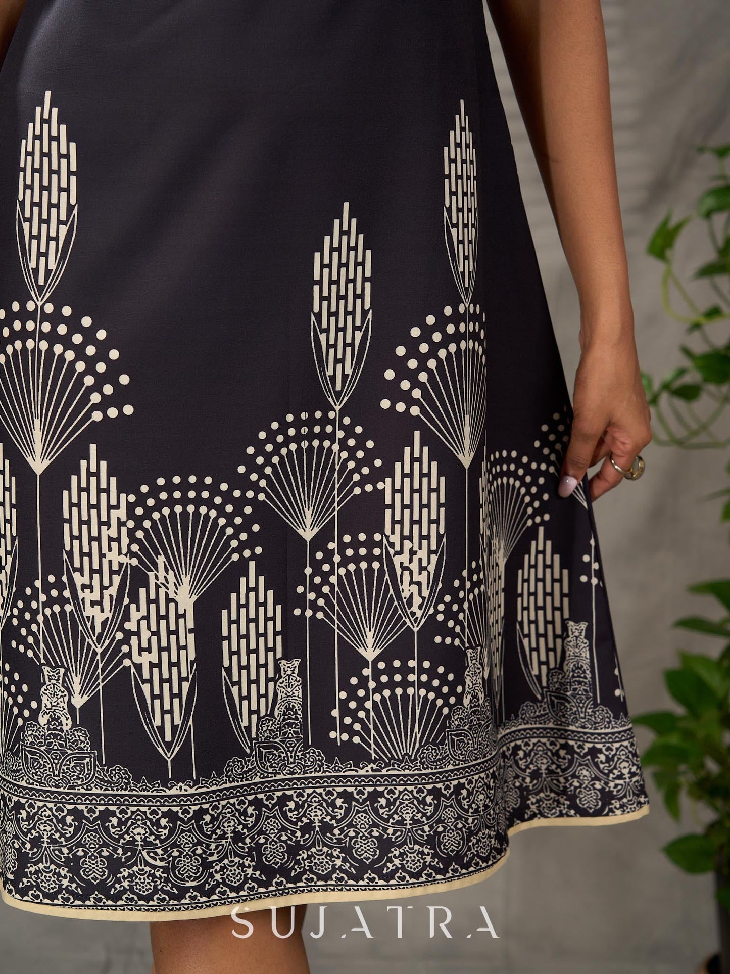 Black digital printed sleeveless dress with straight printed strip neckline and beige accents