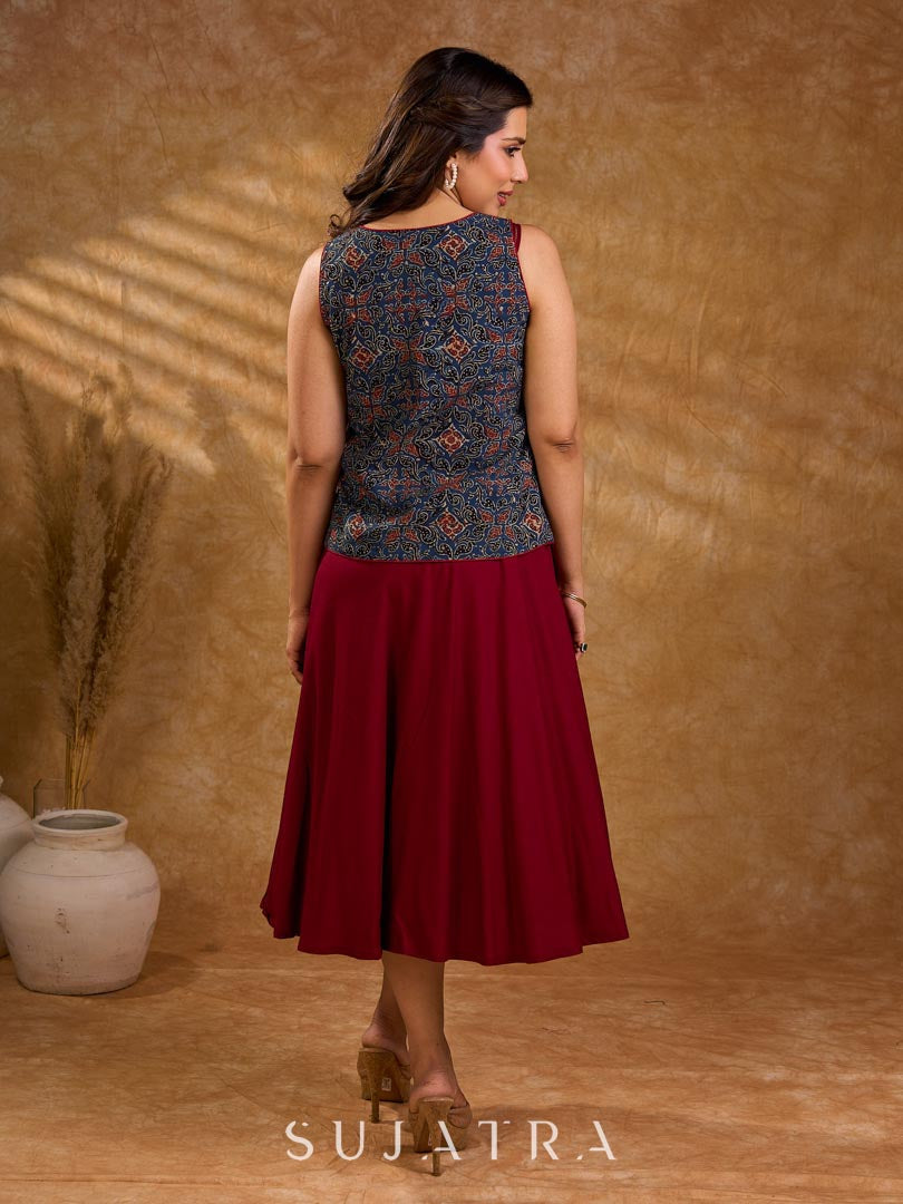 Handcrafted Ajrakh sleeveless jacket featuring front flaps, maroon detailing, breathable fabric, and a contemporary ethnic fusion appeal.