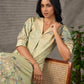 Soft green Kalamkari printed collared dress with centre pleat detailing.