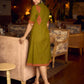 Gorgeous olive dress with pink abstract triangle hand block prints placed at the centre, sleeves, and back, featuring a mandarin collar and half sleeves for a refined, contemporary look.