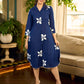 Navy blue apple-cut shirt dress with white floral hand block motifs, conceptually placed and finished with clean white edging and red accents for a refined, contemporary look.