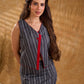 Textured grey Jamdani sleeveless waistcoat with bold red accents and an asymmetrical opening, creating a sharp, modern silhouette with distinctive, fashion-forward appeal.