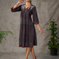 Black Ajrakh printed dress with pleats, maroon accents, and silver embellishments.