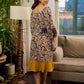 Heritage Kalamkari dress with elegant mustard accents and black pearl embellishments.