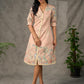 Peach Kalamkari-inspired shirt dress with soft beige accents.