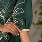 Bottle green and beige half and half dress with raglan sleeves and transitioning floral motifs.